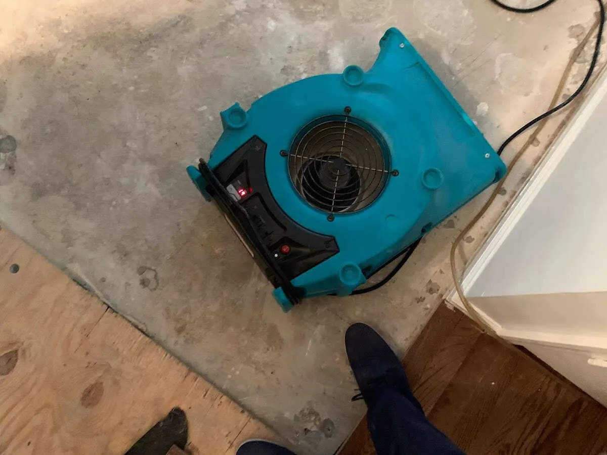 Air mover drying subfloor during Commercial Water Damage Restoration in Glassboro